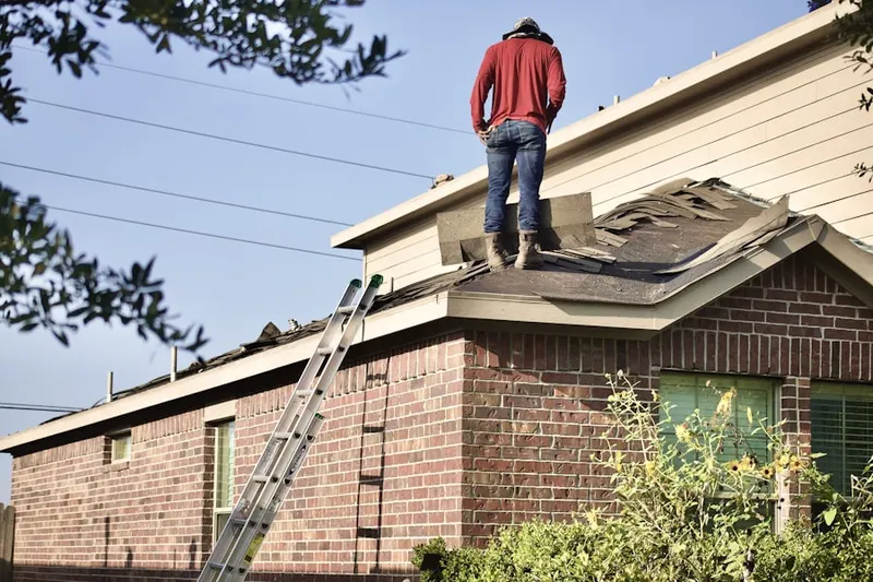 Professional roofer working on a residential roof in Neptune City